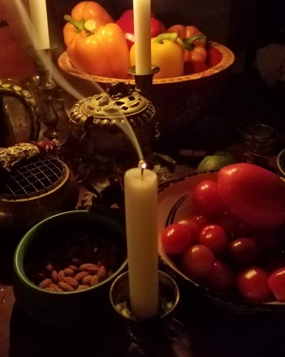 Image of a medieval inspired table with vegetables and candles.